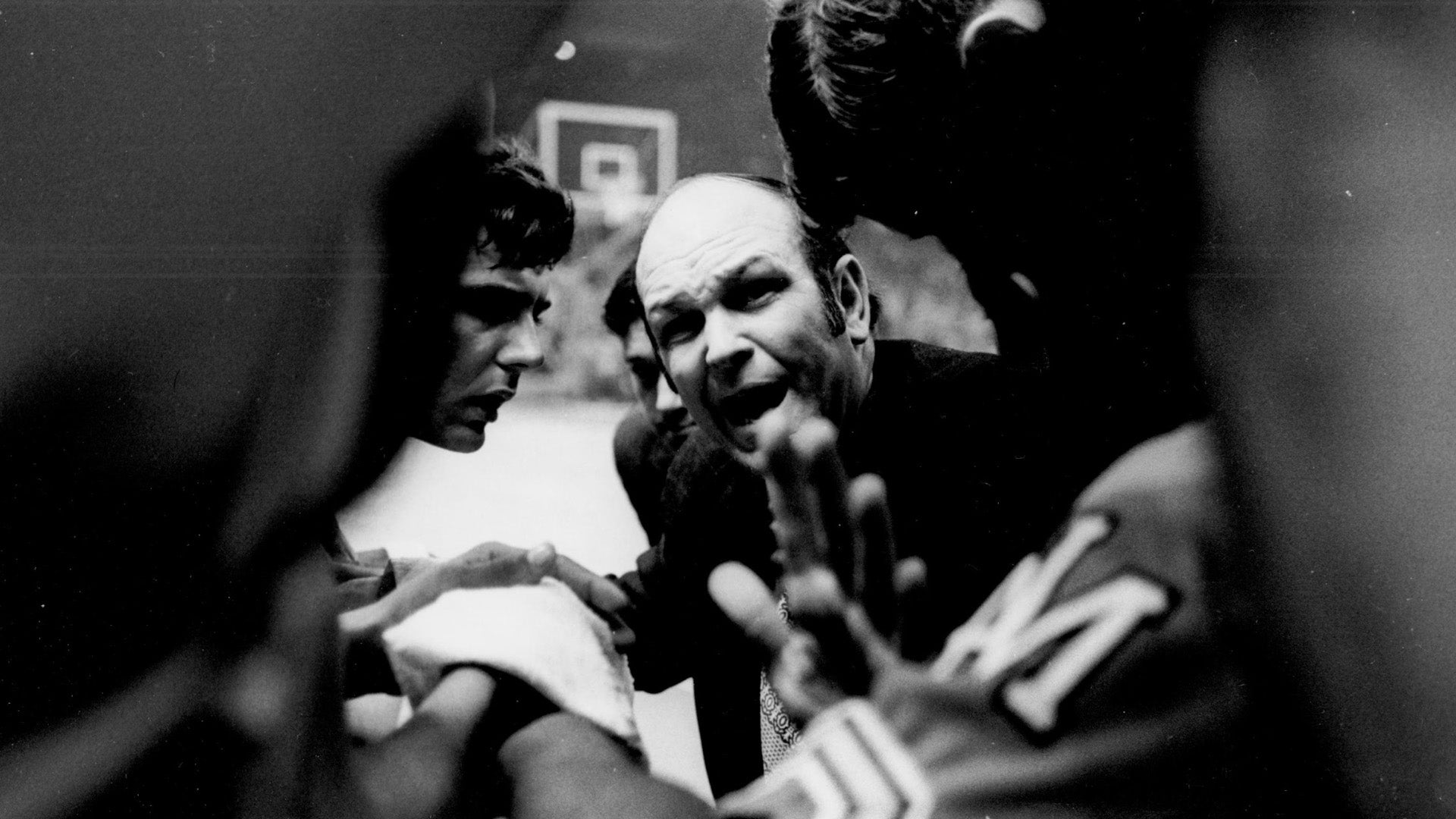 On the documentary the game the changed college basketball, a coach yells to his team during a huddle on the sidelines. Omni United LLC website home page